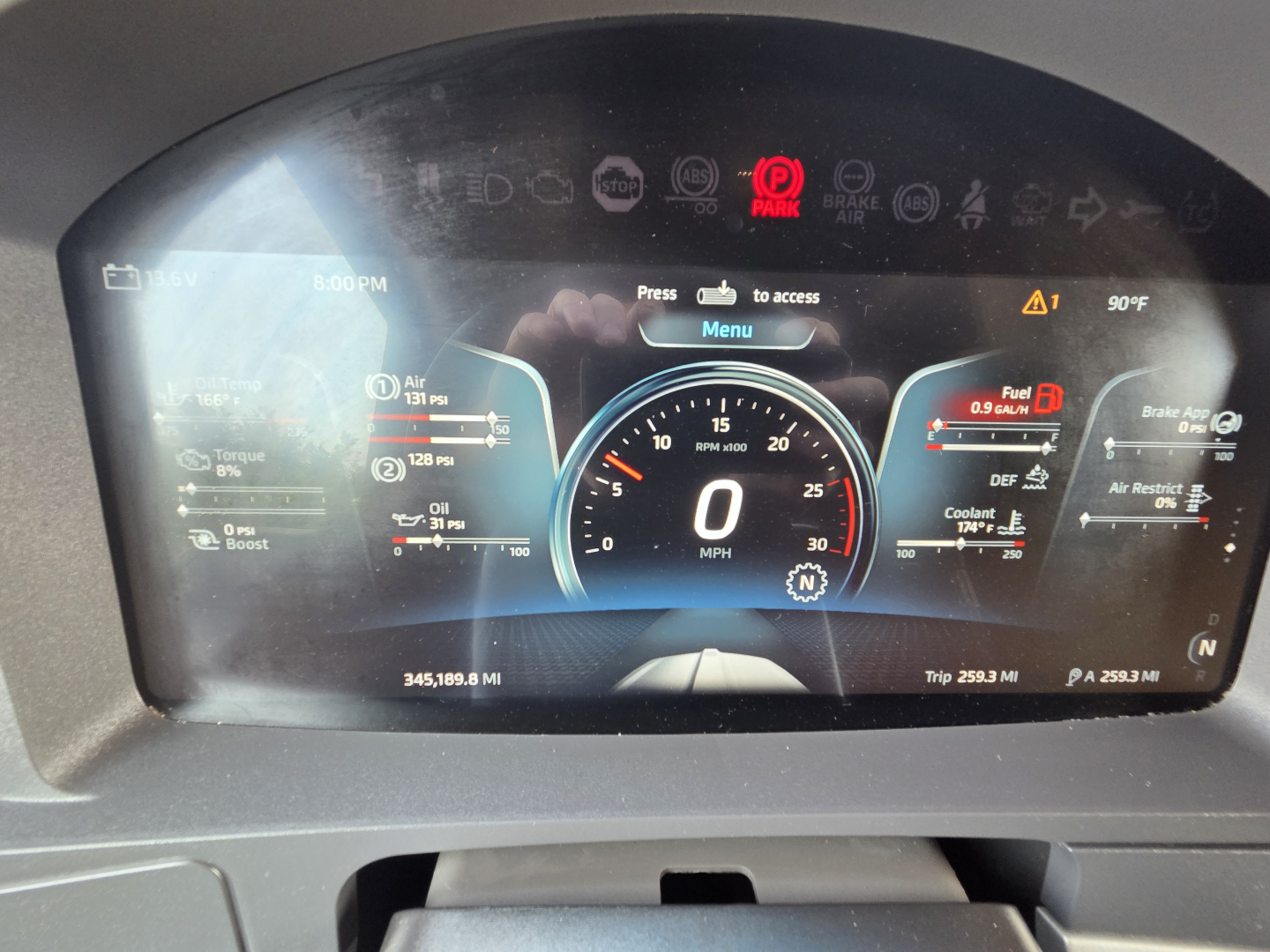 Kenworth T680 instrument cluster display showing digital gauges, warning icons, and vehicle data such as speed 0 MPH, fuel, temperature, and trip meters.