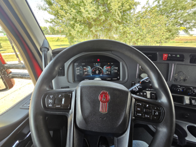 Kenworth T680 dashboard and steering wheel in-cab view showing instrument cluster and controls.