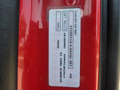 Kenworth T680 chassis label with model T680, weight 11758 lbs, VIN 1XKYD49X9PJ230224 on door jamb of red truck