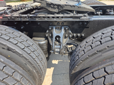 Kenworth T680 chassis and suspension showing undercarriage with dual rear axles and leaf spring, no visible fluids labels.