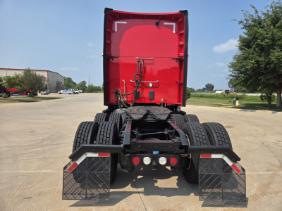Kenworth T680 rear view showing fifth wheel and dual rear axles in a service yard.