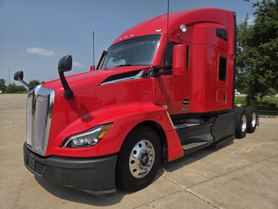 Red Kenworth T680 tractor side view showing cab, front grille, headlights, and dual rear axles with chrome wheels.