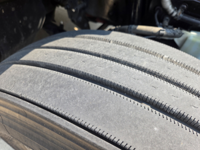 Kenworth T680 wheel and tire close-up showing tread and sidewall.