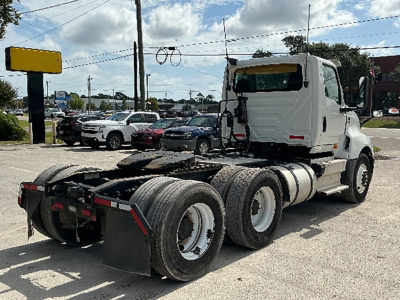 International LT625 conventional daycab truck chassis showing rear triple-axle tandem and cab with VIN plate not visible.