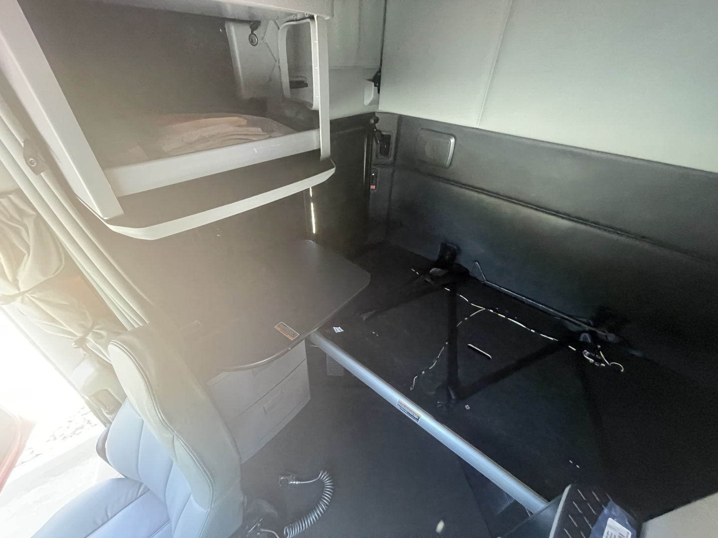 Kenworth T680 truck interior cargo area with bunk and storage compartments visible.