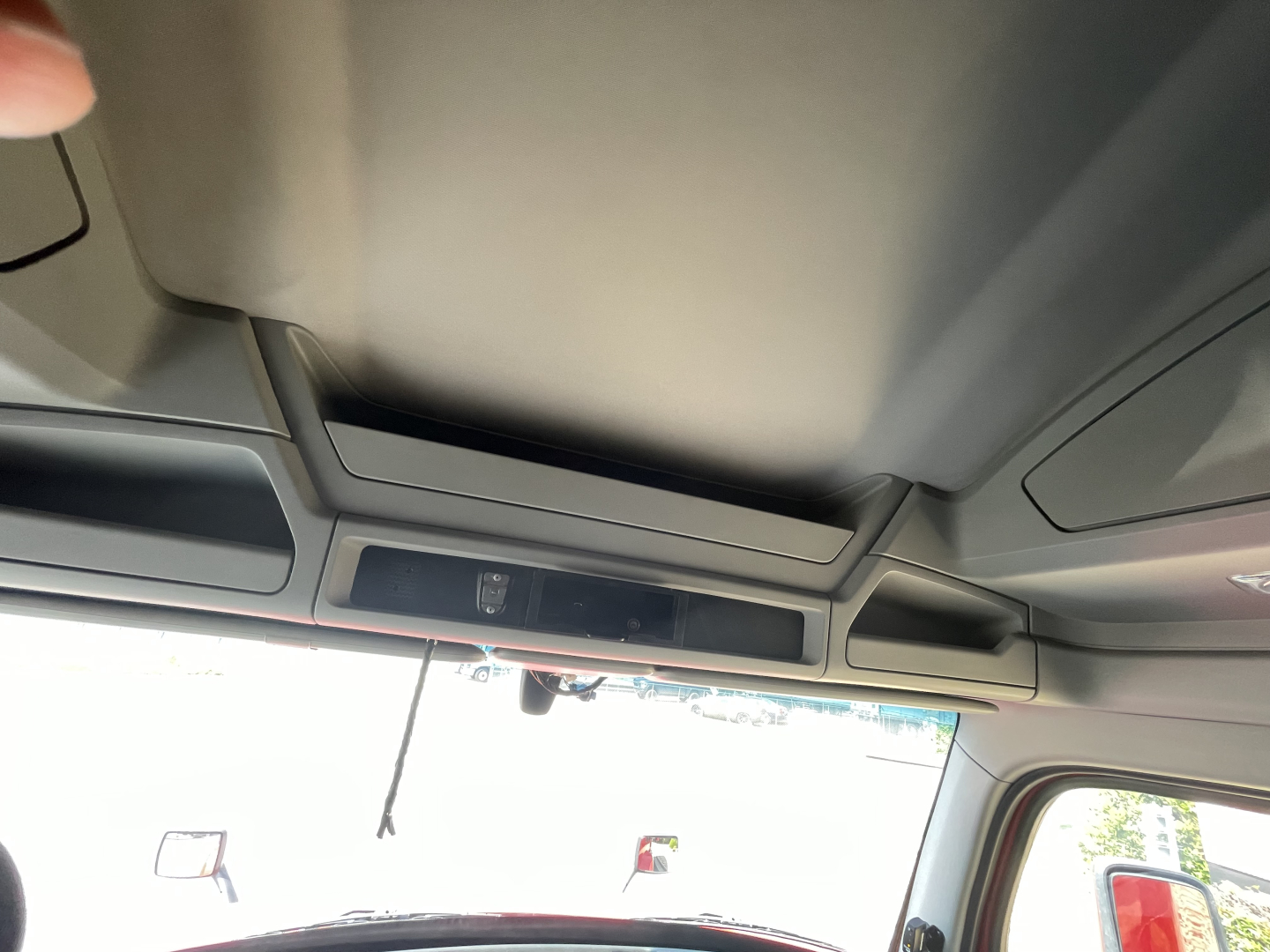 Kenworth T680 interior view with overhead console and sun visor.