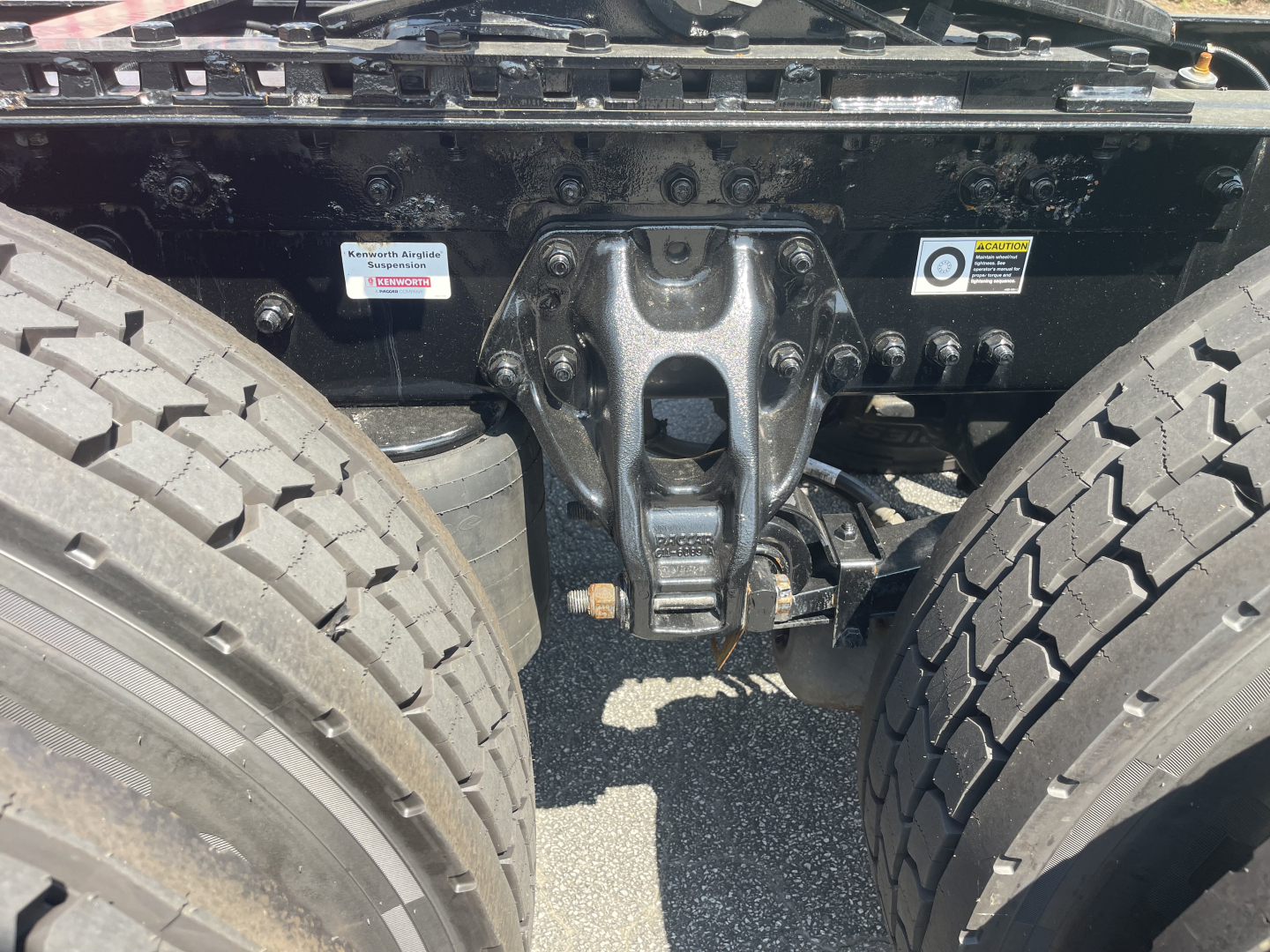 Kenworth T680 rear chassis with fifth wheel mount and dual rear tires,view of underframe and hardware.