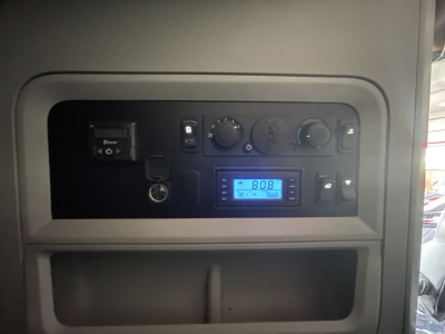 Kenworth T680 dash panel with digital display showing 808 and assorted gauges.