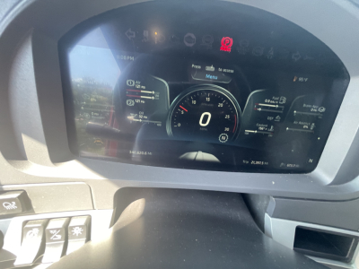 Digital instrument cluster of a Kenworth T680 showing 0 mph and various gauges and warning icons.