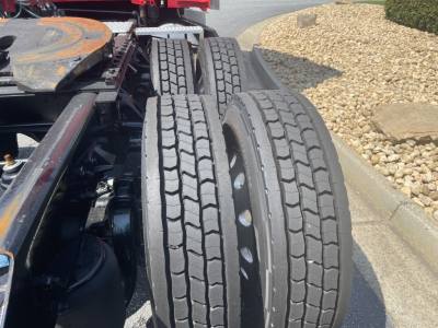 Kenworth T680 truck rear dual tires and chassis drivetrain components visible.
