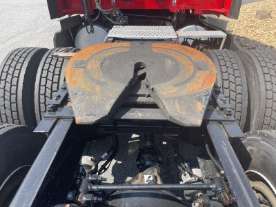 Kenworth truck fifth wheel plate and rear chassis with dual rear axles, visible undercarriage and landing gear components.