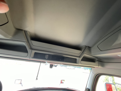 Kenworth T680 interior view with overhead console and sun visor.