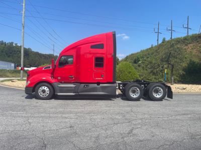 Kenworth T680 semi truck in red, side view with sleeper cab and dual rear axles, no visible text on the vehicle.