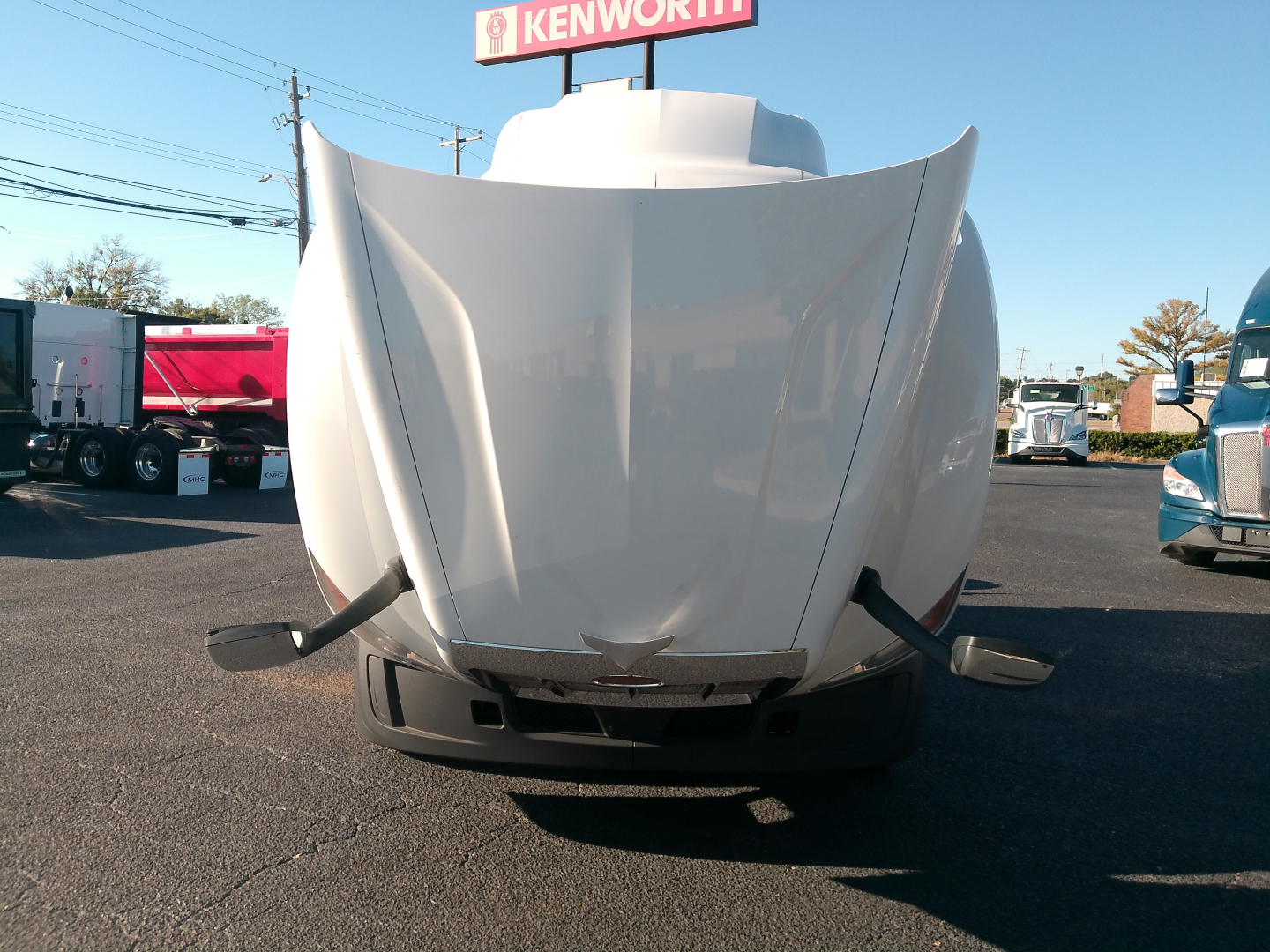 Peterbilt 579 front view showing hood with raised center and bumper, in a used truck lot.
