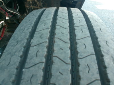 Truck tire tread close-up on Peterbilt 579 showing wear pattern and sidewall area; no other components visible.