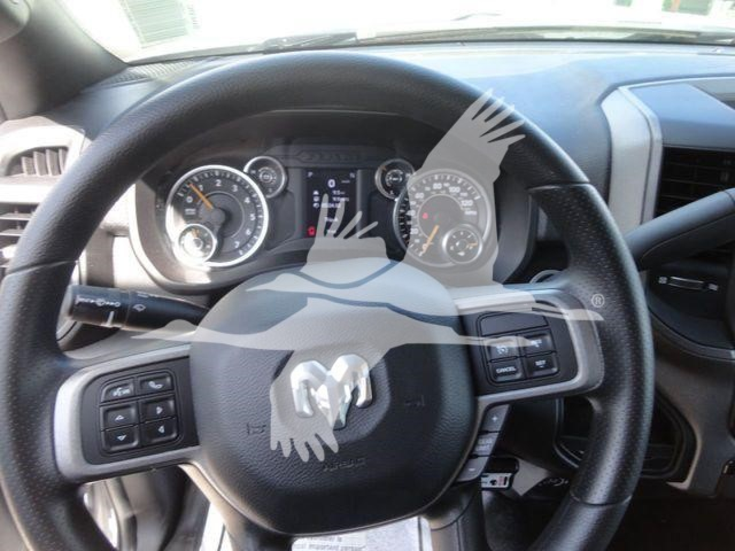 Ram steering wheel and instrument cluster in cab of 2024 Ram 5500 HD showing dashboard controls and gauges.