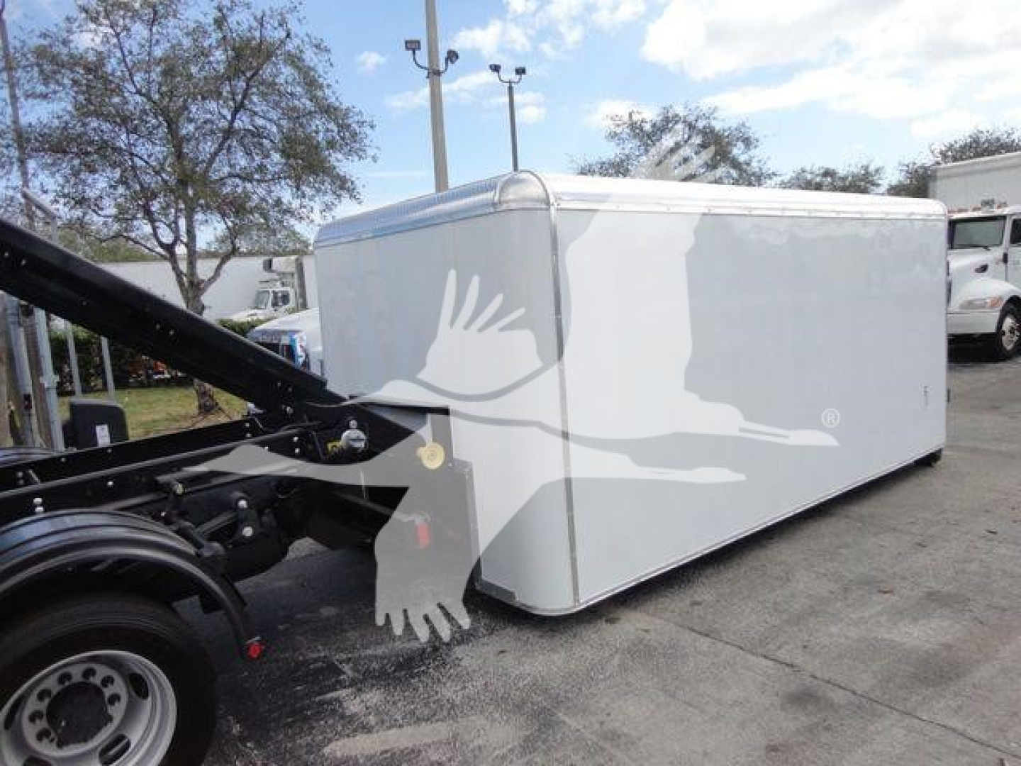 Ram 5500 HD truck with a white enclosed cargo trailer attached in a parking lot.