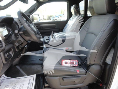 Ram 5500 HD interior view showing driver seat and front passenger seat with steering wheel, center console, plastic-wrapped seat, and dashboard details.