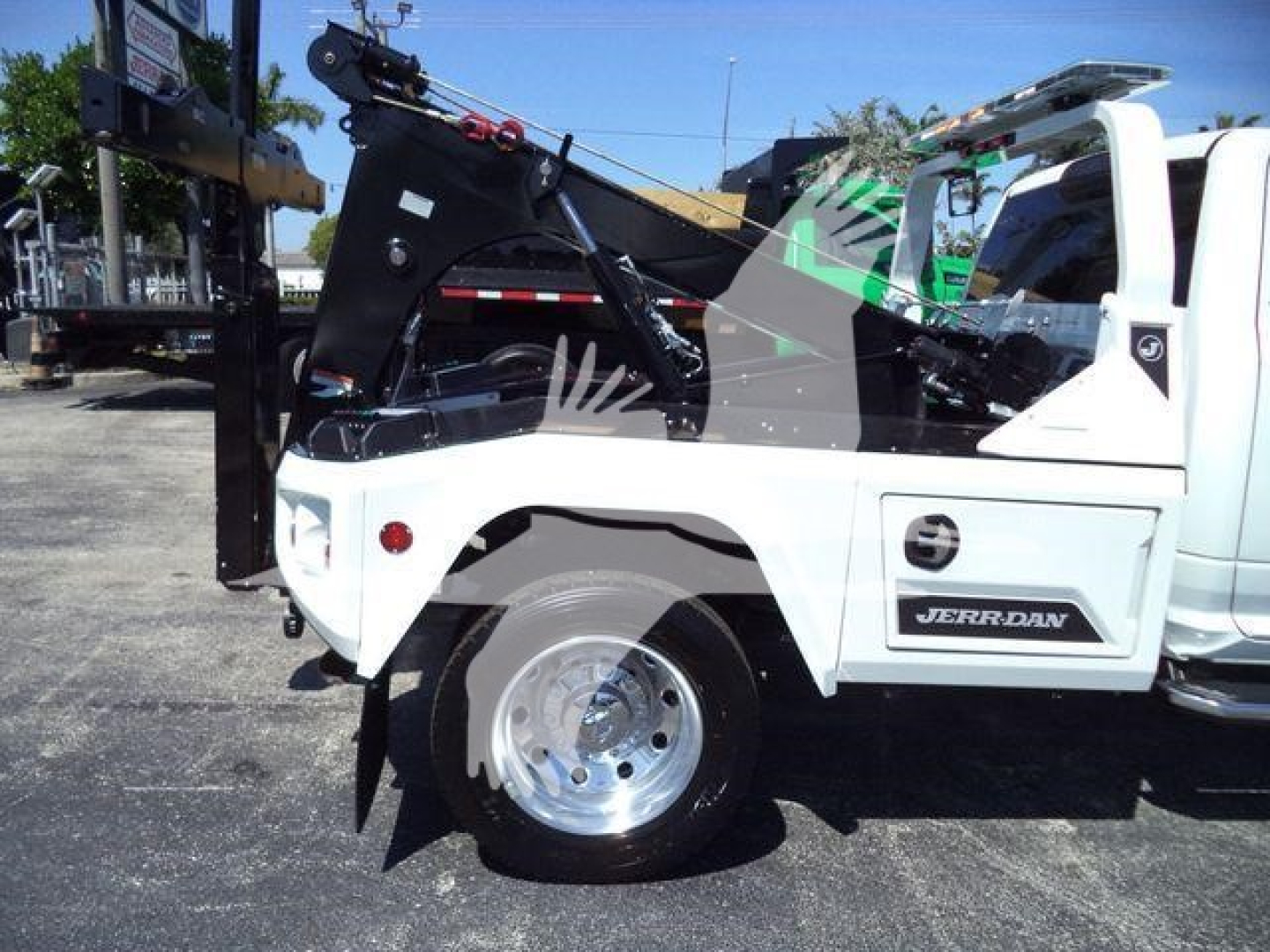 Ram 5500 winch truck side view showing white cab and JERRDAN label and heavy-duty equipment