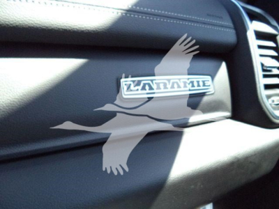 Ram 5500 Laramie badge on dashboard with wind deflector and logo visible