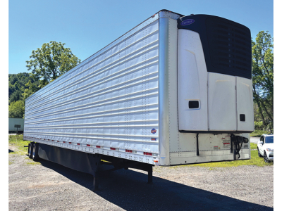 Utility 3000R trailer with reefer unit at front, side railings, and landing gear visible.