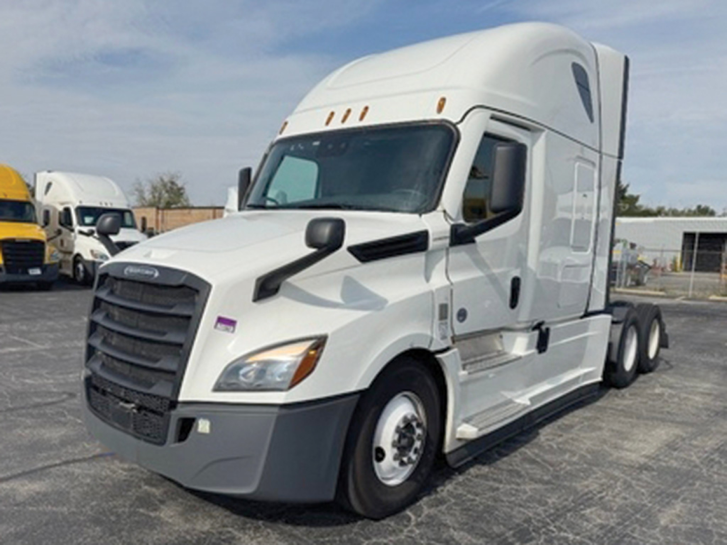 Truck image: 2022 Freightliner Cascadia126 semi truck in a parking lot viewed from the front-left side, white cab, black grille, dual rear axles, no visible damage.