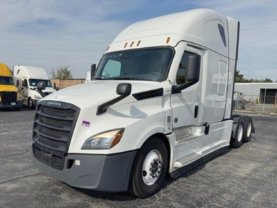 Truck image: 2022 Freightliner Cascadia126 semi truck in a parking lot viewed from the front-left side, white cab, black grille, dual rear axles, no visible damage.