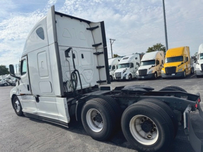 Freightliner Cascadia126 truck tractor side view showing cab and dual rear axles with fifth wheel, front windshield, and sleeper cab