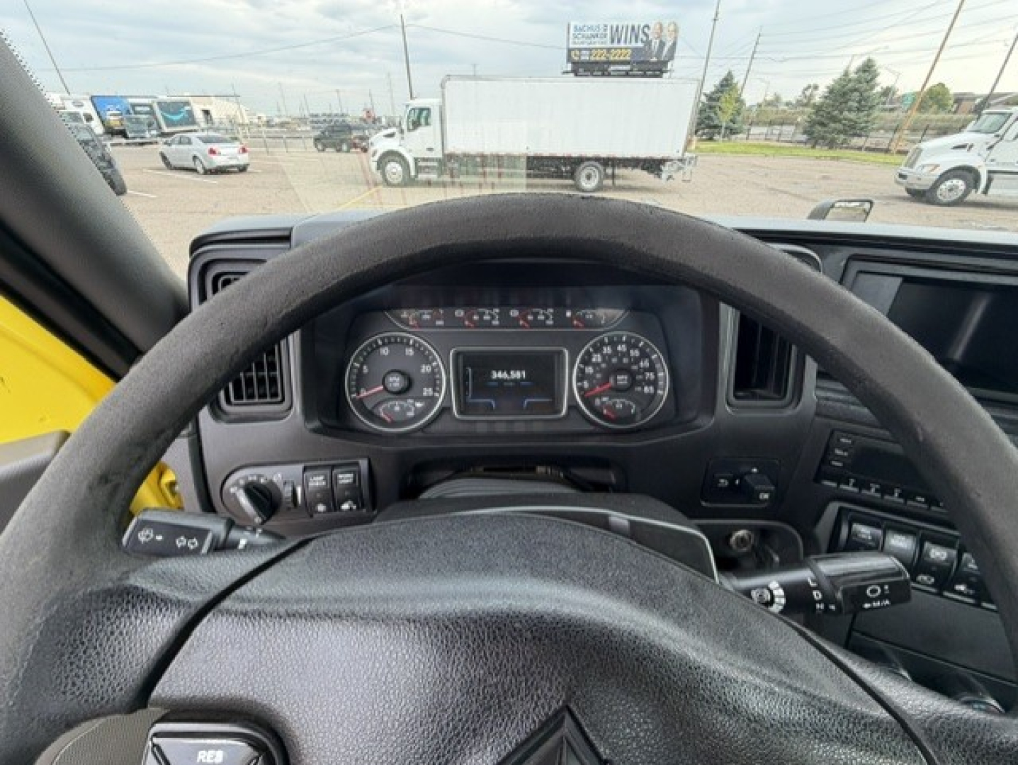 Interior view of a 2023 International LT625 cab showing steering wheel and dashboard gauges.
