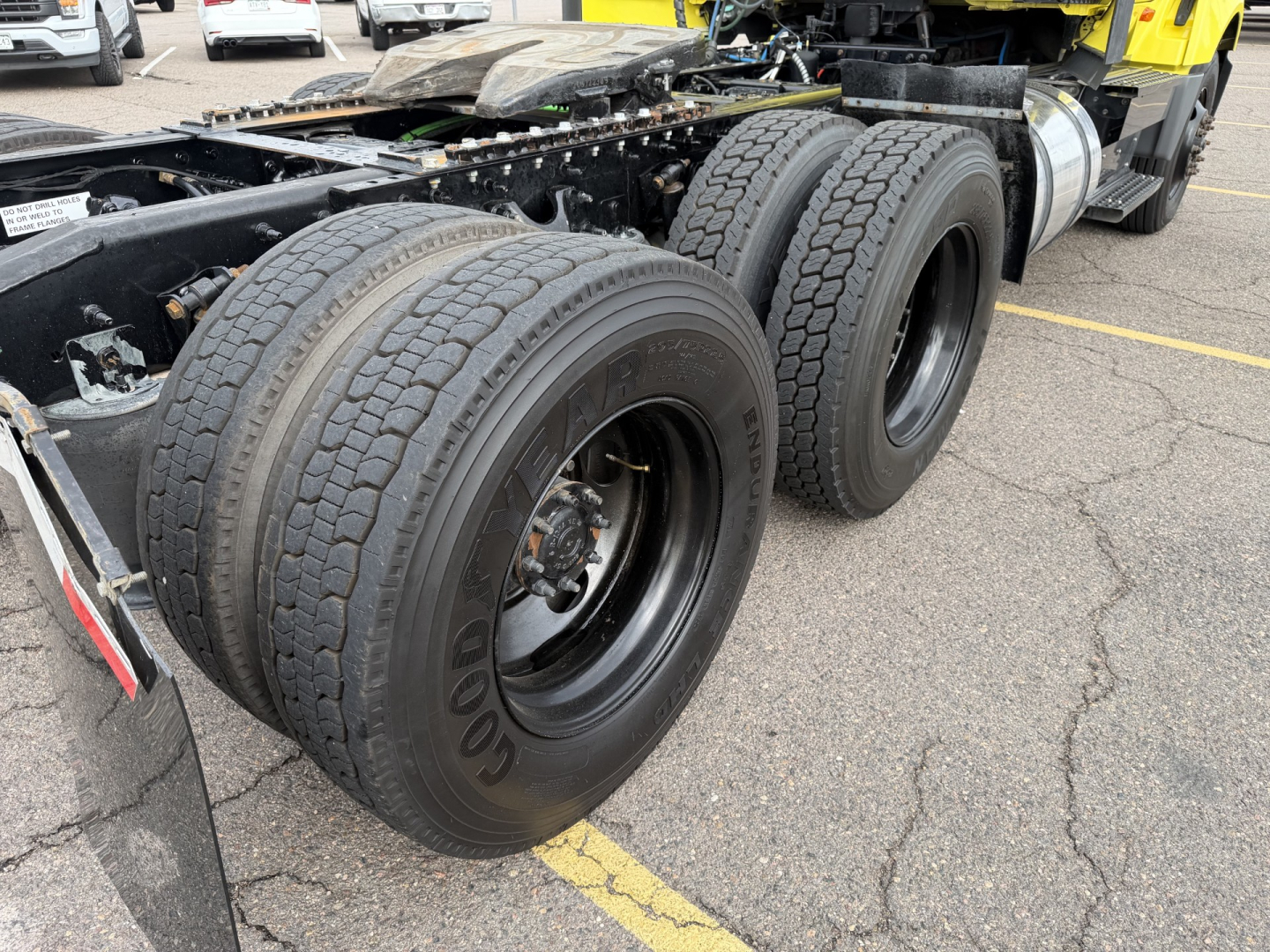 International LT625 truck rear dual axle wheels and tires in view.