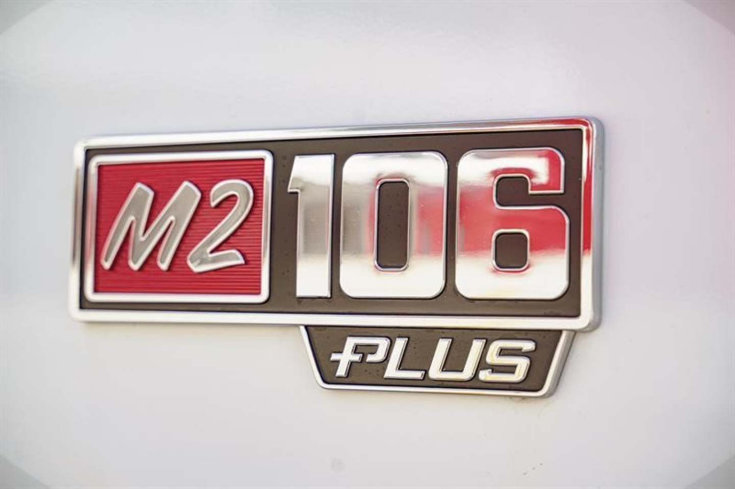 Freightliner M2 106 Plus badge on truck exterior showing M2 106 Plus logo.