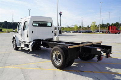 Freightliner M2 106 Plus cab and chassis showing rear flatbed/frame with wheel and suspension, white cab, stock number 352644.