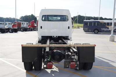 Freightliner M2 106 Plus cab and chassis rear view showing drivetrain and rear lights.
