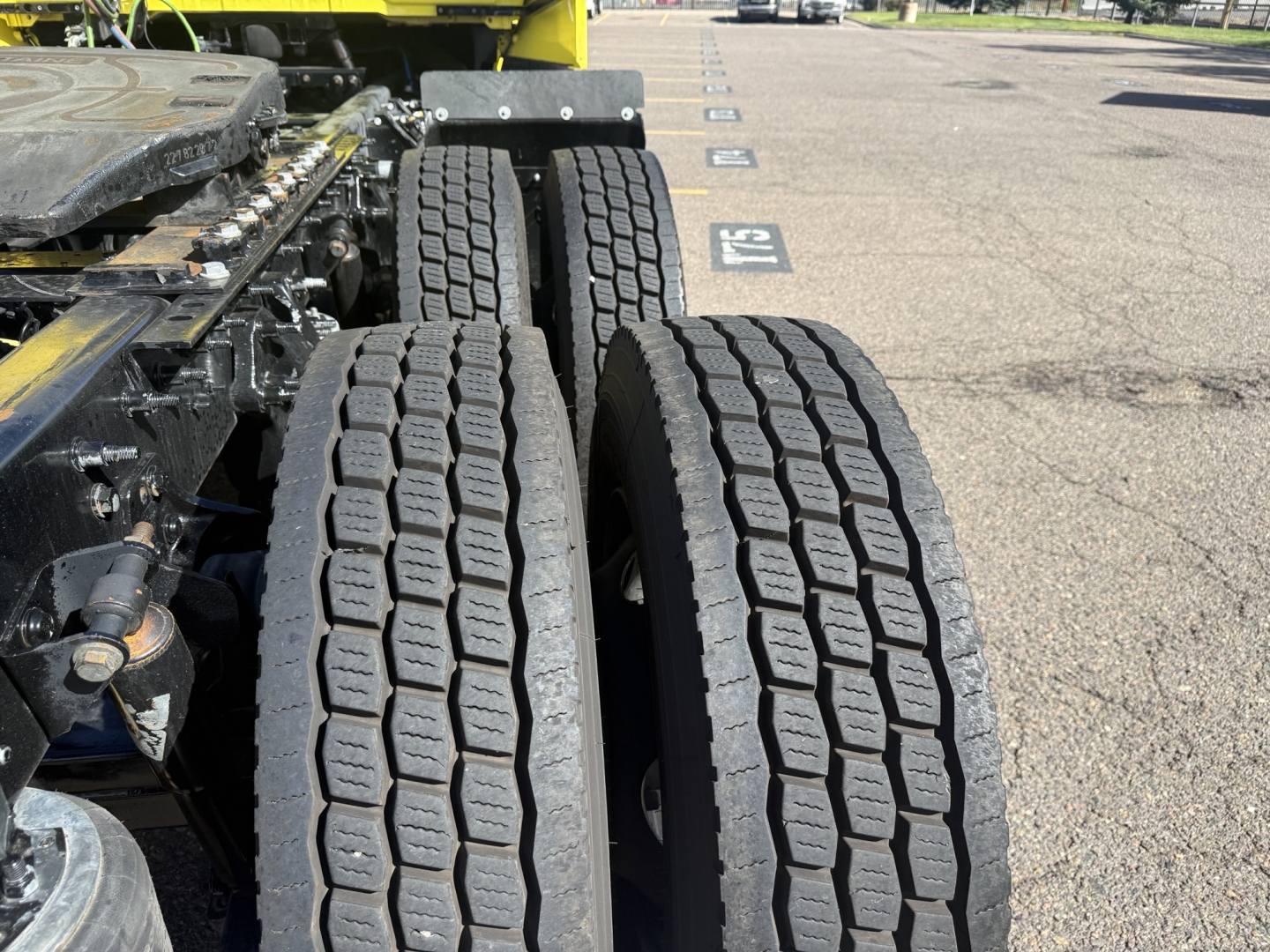 Dual rear truck tires on a 2023 International LT625 conventional daycab, showing tread pattern and wheel rims with surrounding chassis components.