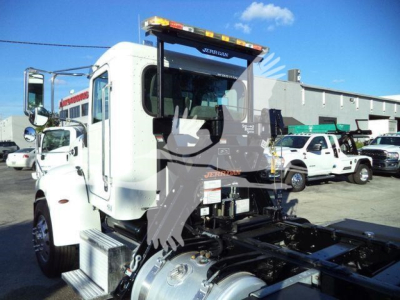 Peterbilt 337 rollback truck cab and chassis showing VIN plate area and rear hitch assembly