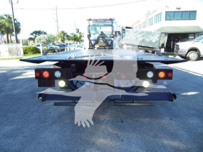 Peterbilt 337 rollback service body rear view showing taillights and hydraulic bed with platform extended.