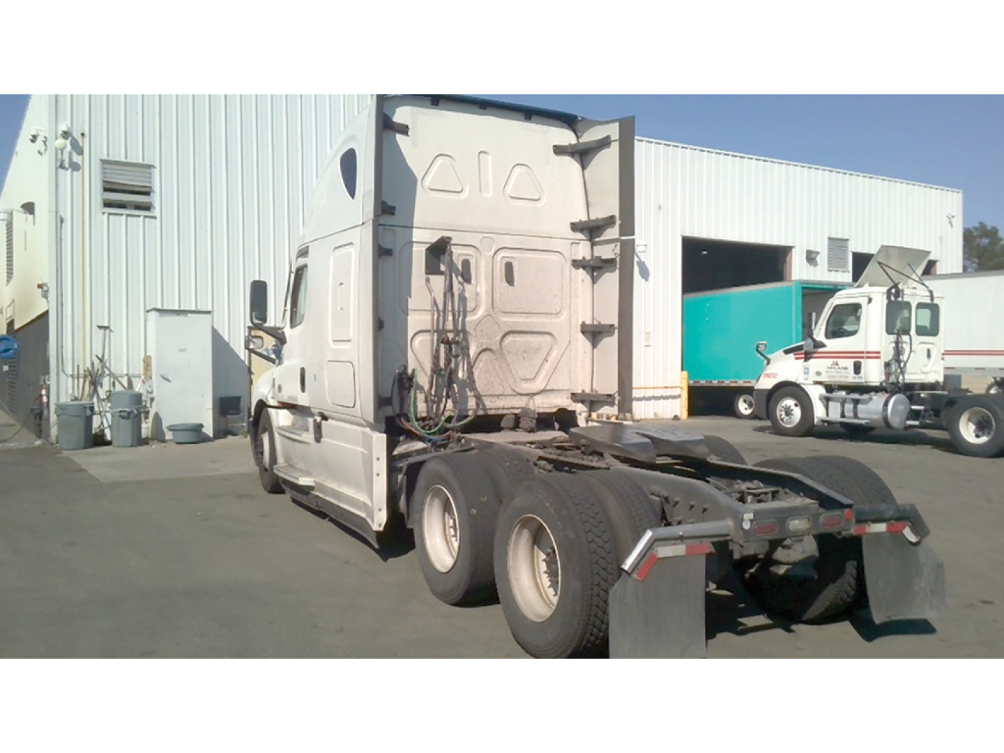 Freightliner Cascadia126 truck tractor rear and sleeper cab view showing fifth wheel and rear wheels.