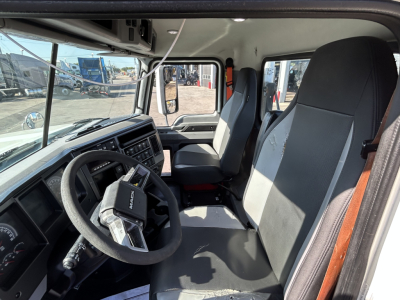 Interior of a 2020 Mack PI64T truck cab showing steering wheel, driver's seat, and dashboard with digital gauges and controls.