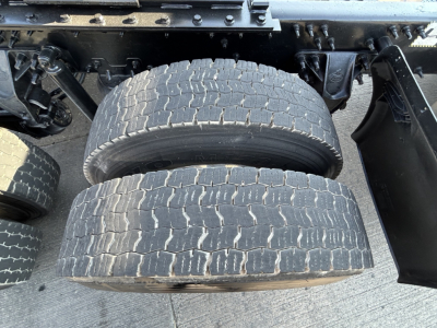 Two rear dual tires of a 2020 Mack PI64T truck showing tread patterns and wheel rims.