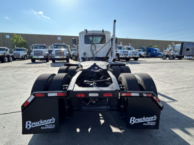 Rear view of a 2020 Mack PI64T conventional daycab truck showing dual rear axles and fifth wheel area