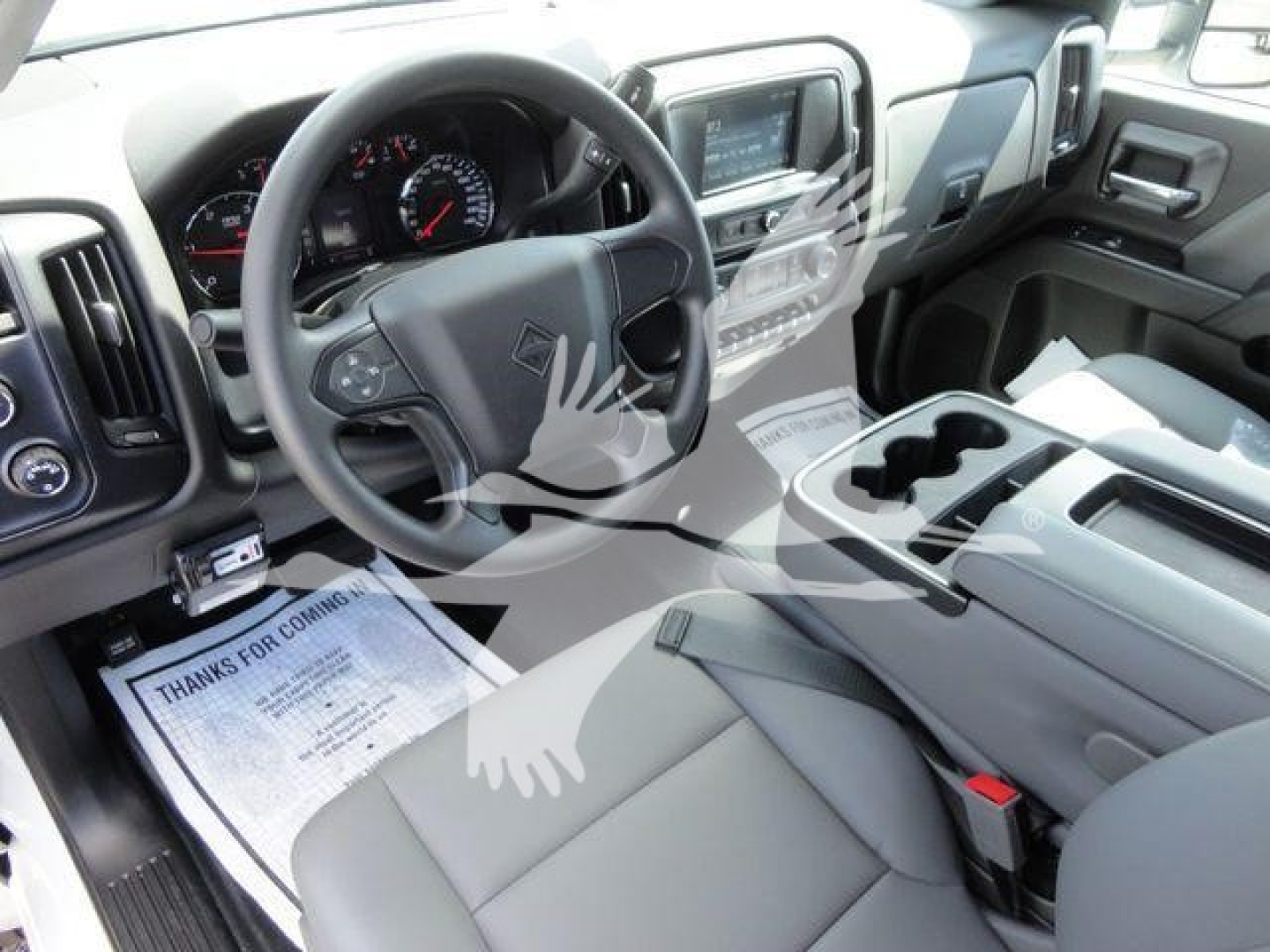 Cab interior of a 2023 International CV dump truck showing steering wheel, driver seat, center console, and dashboard with gauges.