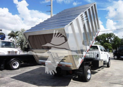 Dump truck with a metal dump body raised on a white cab chassis, label 4X4CV14CHIPPER stock number, side view showing open toolbox and rear wheels.