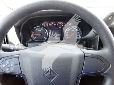 Dashboard and steering wheel of a 2023 International CV dump truck showing instrument cluster and steering wheel emblem.