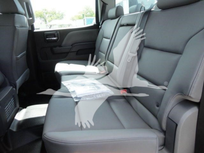 Interior of 2023 International CV dump truck showing rear seating with gray leather seats and a folded brochure on the middle seat.