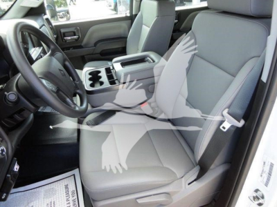 Interior cab view of a 2023 International CV dump truck showing front seats, steering wheel, center console with cupholders, and seat belts.