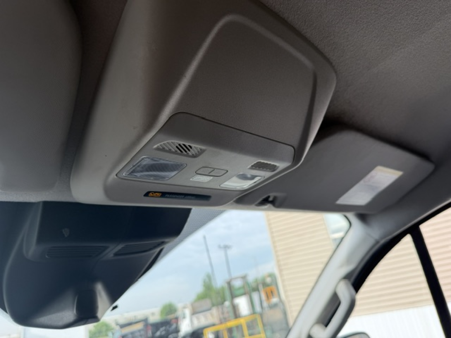 Overhead console and sunroof area inside a Ford Transit/Truck cabin showing interior map lights and controls.