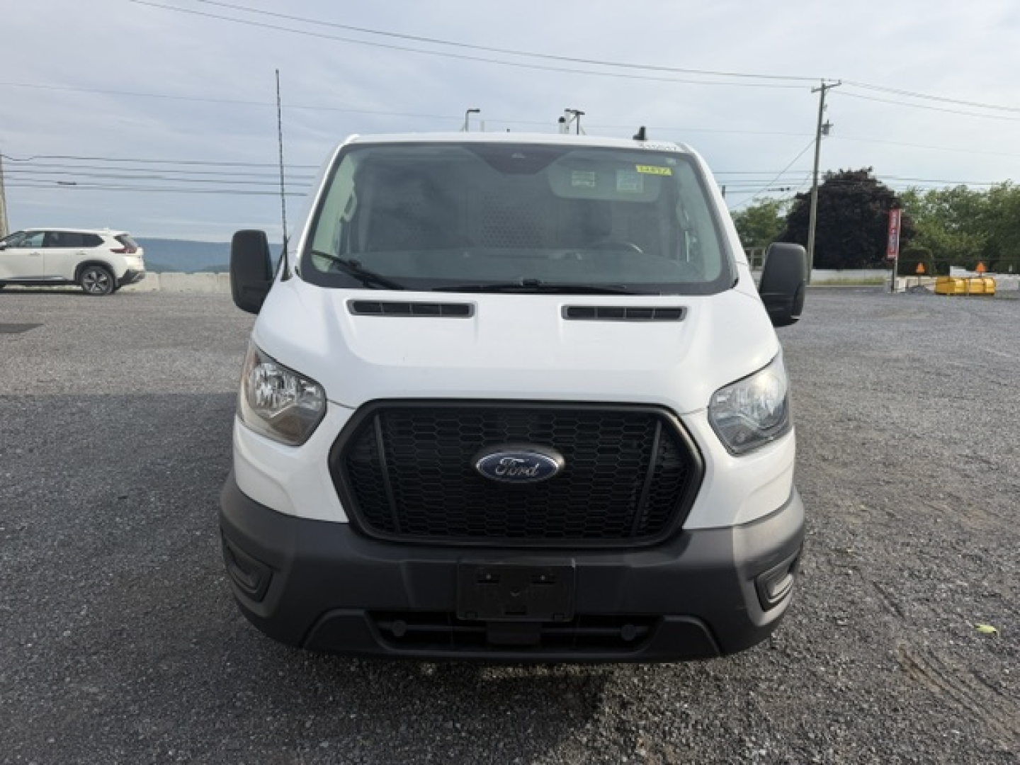 Front view of a white 2021 Ford TRAN250 service/utility truck showing Ford emblem grille and black front bumper.