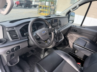 Ford Transit/Truck interior showing steering wheel, dashboard, and center console with touchscreen display.
