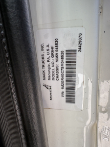 Mack Trucks label on door jamb with VIN 1M2GR4GC7SM048520 and model/serial information clipped sticker.