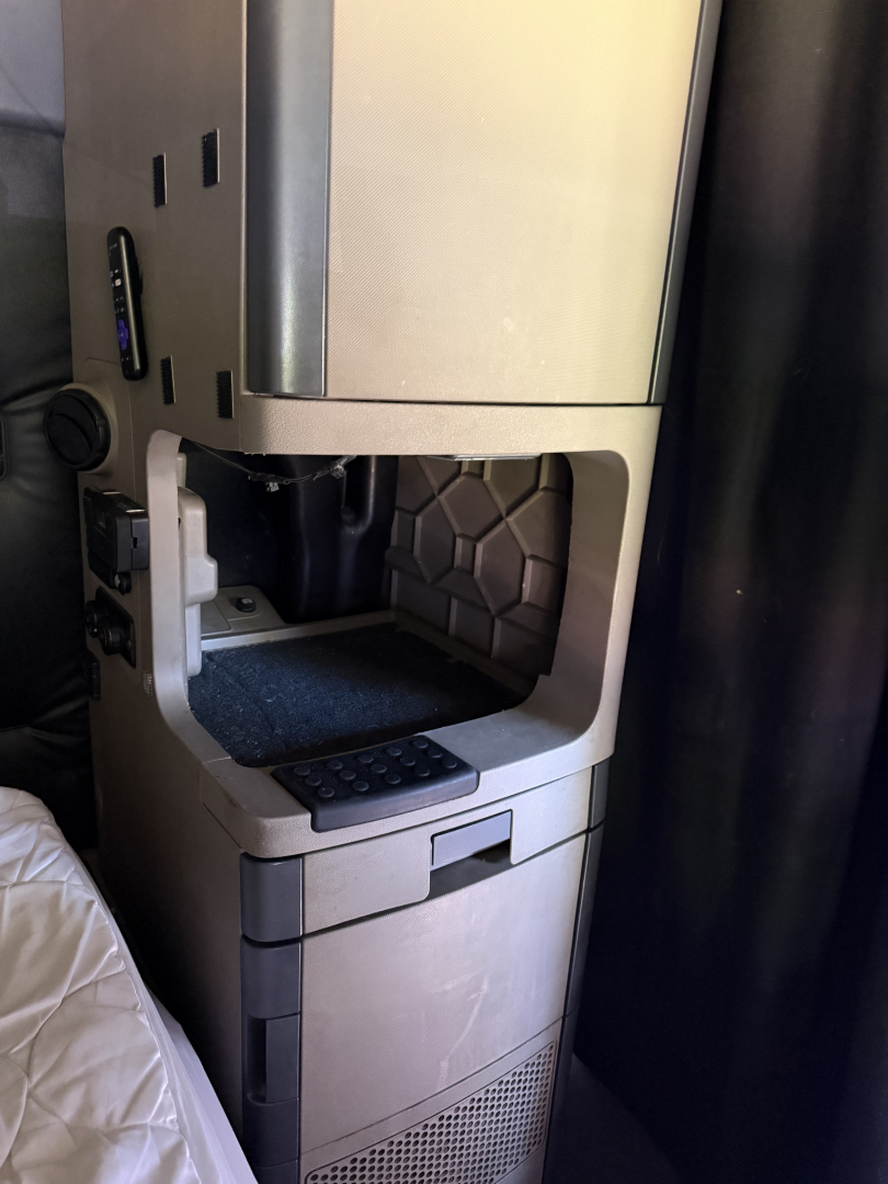 Cab/console area of a Freightliner Cascadia Evolution truck showing a storage/driver area and entry steps.